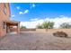 Backyard view of two-story house, showing a covered patio and gravel area at 18774 N Ibis Way, Maricopa, AZ 85138