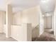 Upper level hallway with carpeted floor and doors to bedrooms at 18774 N Ibis Way, Maricopa, AZ 85138