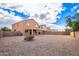 View of two-story house from the backyard, showing a covered patio at 18774 N Ibis Way, Maricopa, AZ 85138