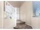 Indoor view of carpeted staircase with white railings and a window at 18774 N Ibis Way, Maricopa, AZ 85138