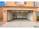 Attached two-car garage with overhead storage shelving at 18774 N Ibis Way, Maricopa, AZ 85138