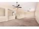 Large bedroom with high ceilings, two ceiling fans, and multiple windows at 18774 N Ibis Way, Maricopa, AZ 85138