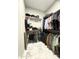 Spacious walk-in closet with custom shelving and hanging rods at 25979 W Taro Dr, Buckeye, AZ 85396