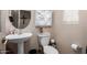 Clean bathroom with pedestal sink, toilet and decorative accents at 4199 E Desert Sands Pl, Chandler, AZ 85249