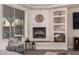 Cozy corner fireplace with built-in shelving and clock at 8052 E Mcdowell Rd, Mesa, AZ 85207