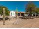 Single-story home with desert landscaping and a red front door at 8052 E Mcdowell Rd, Mesa, AZ 85207