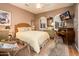 Bedroom with a queen-size bed, wicker furniture, and a view of the bathroom at 23228 N Gaviota Dr, Sun City West, AZ 85375