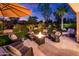 Evening view of patio with fire pit and seating at 23228 N Gaviota Dr, Sun City West, AZ 85375