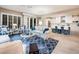 Open living room features spacious seating, a decorative rug, and a view into the kitchen at 23228 N Gaviota Dr, Sun City West, AZ 85375