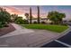 House exterior with grassy area and walkway at sunset at 23228 N Gaviota Dr, Sun City West, AZ 85375