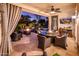 Covered patio with seating area, fire pit, and outdoor dining at 23228 N Gaviota Dr, Sun City West, AZ 85375