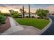 House exterior with grassy area and walkway at sunset at 23228 N Gaviota Dr, Sun City West, AZ 85375