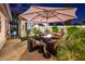 Evening view of a relaxing patio with fire pit and seating area at 23228 N Gaviota Dr, Sun City West, AZ 85375