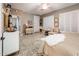 Bedroom with king bed and sitting area near en-suite bath at 23228 N Gaviota Dr, Sun City West, AZ 85375