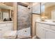 Walk-in shower with stone tile and built-in seat at 23228 N Gaviota Dr, Sun City West, AZ 85375