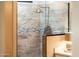 Modern shower with tile surround and glass enclosure at 23228 N Gaviota Dr, Sun City West, AZ 85375