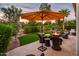Outdoor patio furniture with fire pit and umbrella at 23228 N Gaviota Dr, Sun City West, AZ 85375