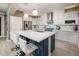 Modern kitchen with white cabinets, a large island with seating, and stainless steel appliances at 23228 N Gaviota Dr, Sun City West, AZ 85375