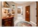 Elegant entryway with wood console table and statement art at 23228 N Gaviota Dr, Sun City West, AZ 85375