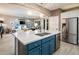 Island kitchen with stainless steel appliances and blue cabinetry at 23228 N Gaviota Dr, Sun City West, AZ 85375