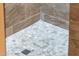 Modern shower with pebble floor and tile surround at 23228 N Gaviota Dr, Sun City West, AZ 85375