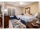 Well-lit bedroom with two twin beds, featuring blue and white bedding and a patterned rug at 23228 N Gaviota Dr, Sun City West, AZ 85375