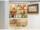 Well-stocked wet bar with ample shelving and glassware at 23228 N Gaviota Dr, Sun City West, AZ 85375
