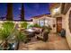 Cozy patio with fire pit and comfortable seating area at night at 23228 N Gaviota Dr, Sun City West, AZ 85375