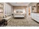 Main bedroom with large bed, sitting area, and en-suite bath at 23228 N Gaviota Dr, Sun City West, AZ 85375