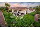Stunning backyard oasis with patio, fire pit, and lush landscaping at 23228 N Gaviota Dr, Sun City West, AZ 85375