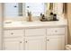 White bathroom vanity with a quartz countertop and ample storage at 23228 N Gaviota Dr, Sun City West, AZ 85375