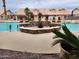 Community pool with a stone fountain and comfortable lounge area at 5830 E Mckellips Rd # 8, Mesa, AZ 85215