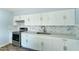Renovated kitchen with white cabinets, marble backsplash, and stainless steel range at 3823 W Augusta Ave, Phoenix, AZ 85051
