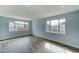 Bright living room with wood-look floors and large windows at 3823 W Augusta Ave, Phoenix, AZ 85051