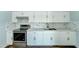 Newly remodeled kitchen with white cabinets and marble tile backsplash at 3823 W Augusta Ave, Phoenix, AZ 85051