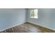 Bedroom with wood-look floors and a window with natural light at 3823 W Augusta Ave, Phoenix, AZ 85051
