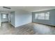 Open living area with wood-look floors and hallway view at 3823 W Augusta Ave, Phoenix, AZ 85051