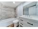 Modern bathroom with white vanity, tile shower, and bathtub at 3823 W Augusta Ave, Phoenix, AZ 85051
