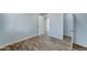 Bedroom with wood-look floors and access to another room at 3823 W Augusta Ave, Phoenix, AZ 85051