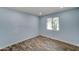 Bright bedroom with wood-look floors and a large window at 3823 W Augusta Ave, Phoenix, AZ 85051