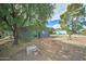 Landscaped front yard with mature trees and xeriscaping at 3823 W Augusta Ave, Phoenix, AZ 85051