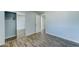 Bedroom featuring wood-look floors and mirrored closet doors at 3823 W Augusta Ave, Phoenix, AZ 85051