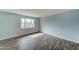 Light and airy bedroom with wood-look floors and a window at 3823 W Augusta Ave, Phoenix, AZ 85051
