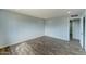 Spacious bedroom with wood-look floors and access to hallway at 3823 W Augusta Ave, Phoenix, AZ 85051