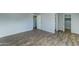 Bright bedroom with wood-look floors and access to bathroom and closet at 3823 W Augusta Ave, Phoenix, AZ 85051