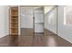 Bedroom with mirrored closet doors, built-in shelving, and wood-look floors at 1920 W Lindner Ave # 137, Mesa, AZ 85202