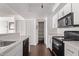 Kitchen with white cabinets, black appliances, and wood floors at 1920 W Lindner Ave # 137, Mesa, AZ 85202