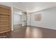 Bedroom with mirrored closet doors, built-in shelving, and wood-look floors at 1920 W Lindner Ave # 137, Mesa, AZ 85202