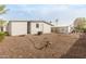 Gravel backyard with AC unit and partial fence at 205 S Higley Rd # 288, Mesa, AZ 85206