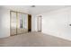 Bedroom with mirrored closet doors and neutral carpeting at 205 S Higley Rd # 288, Mesa, AZ 85206